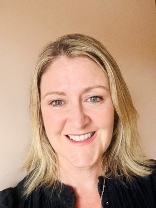 A headshot of Ciara smiling into camera